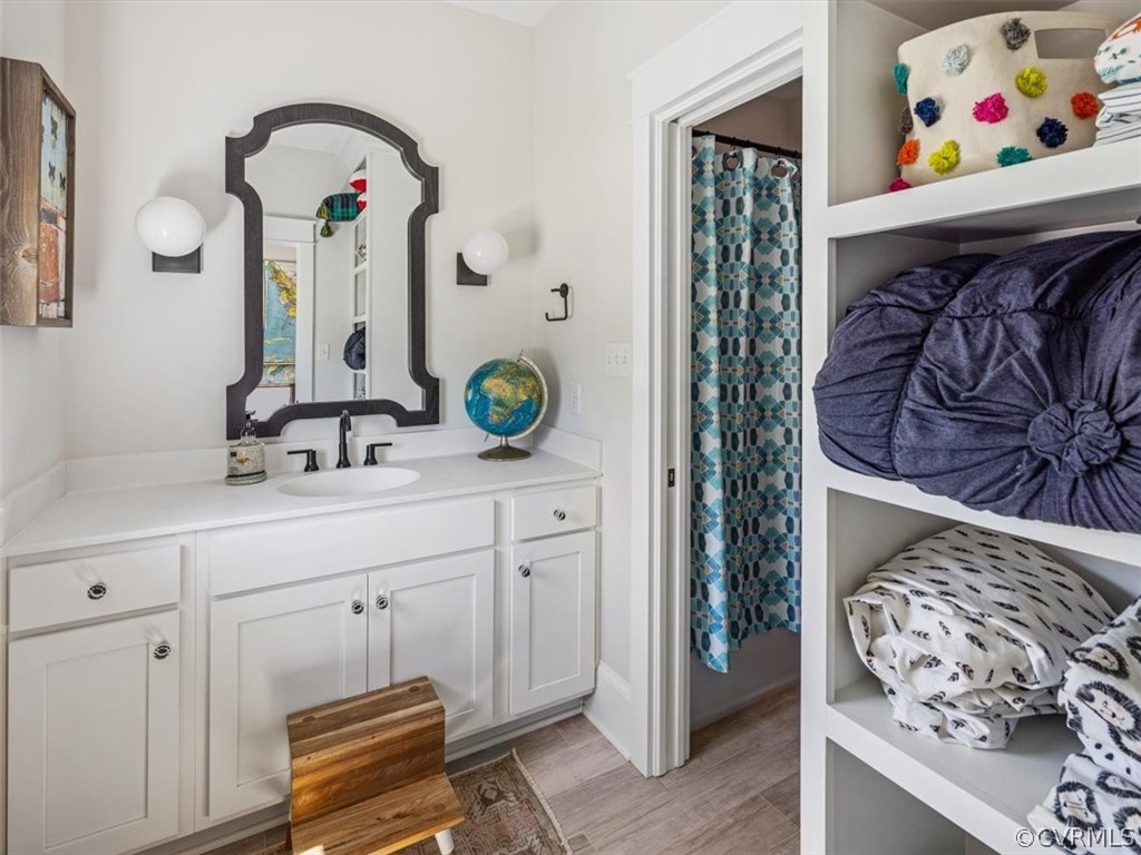16701 Saville Chase Road Midlothian, VA 23112 - Photo 38 of 50 a bathroom with a sink a mirror and painting on the wall