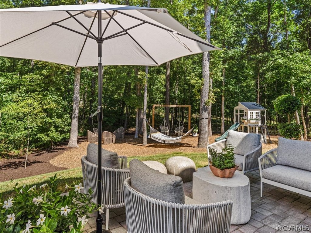 16701 Saville Chase Road Midlothian, VA 23112 - Photo 48 of 50 a view of a patio with couches table and chairs under an umbrella