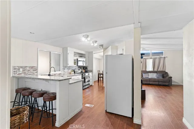a kitchen view with furniture and a refrigerator
