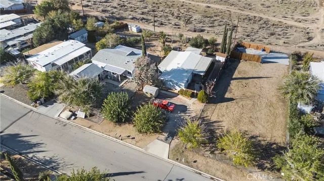 an aerial view of a house with a yard and lake view