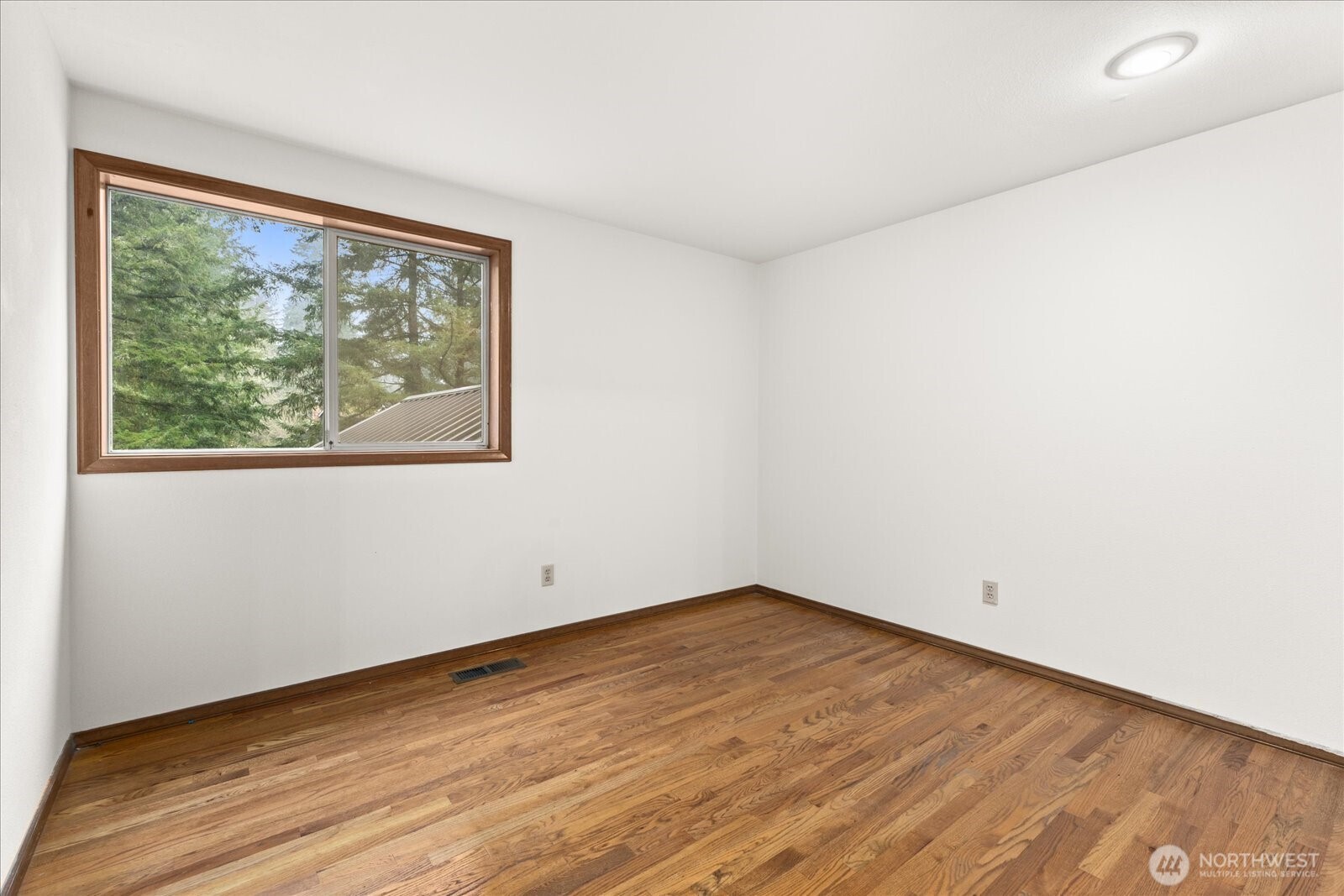 18721 Northeast 133rd Street Redmond, WA 98052 - Photo 22 of 39 a view of empty room with wooden floor and fan