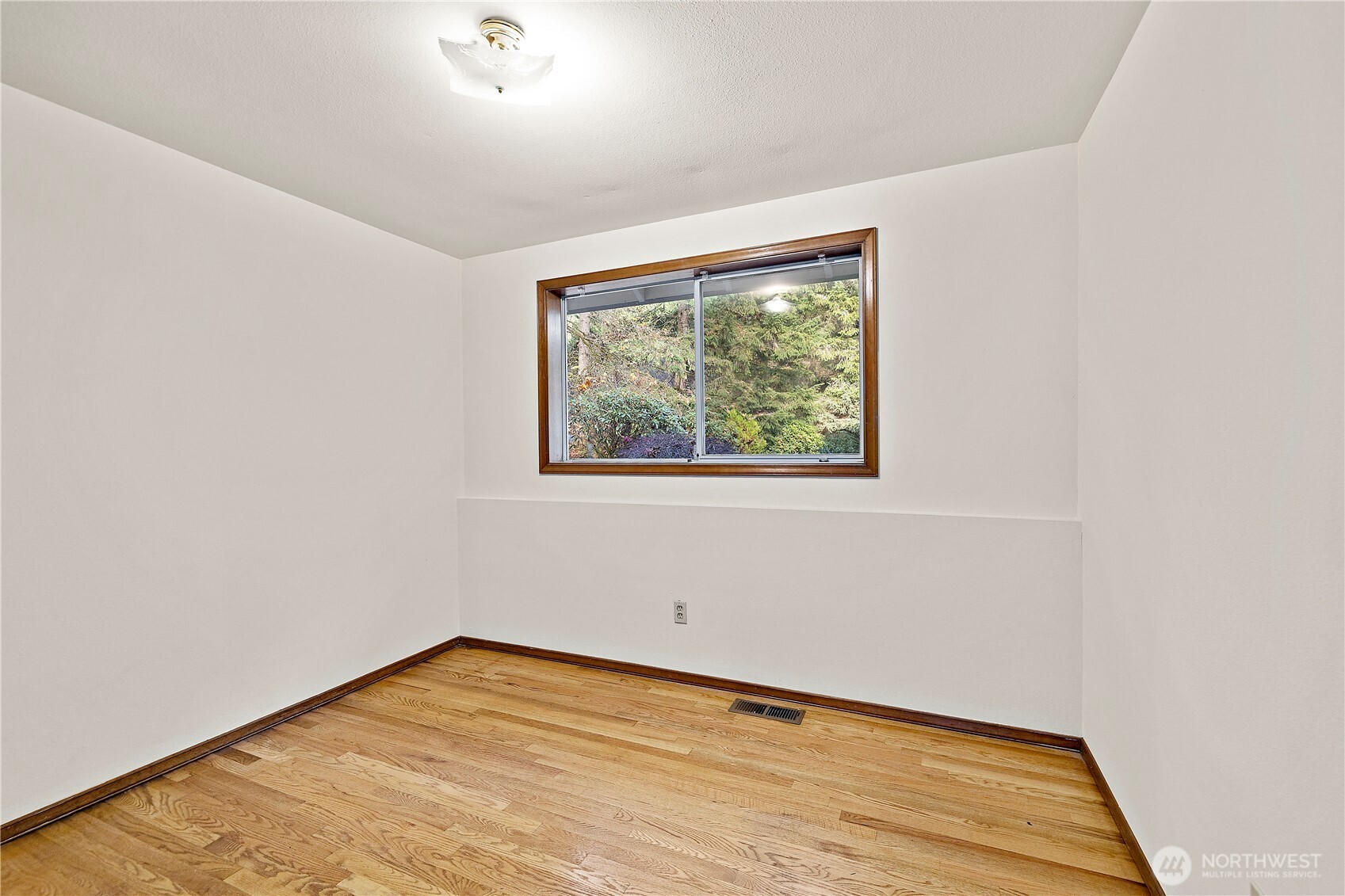18721 Northeast 133rd Street Redmond, WA 98052 - Photo 28 of 39 a view of an empty room with wooden floor and a window