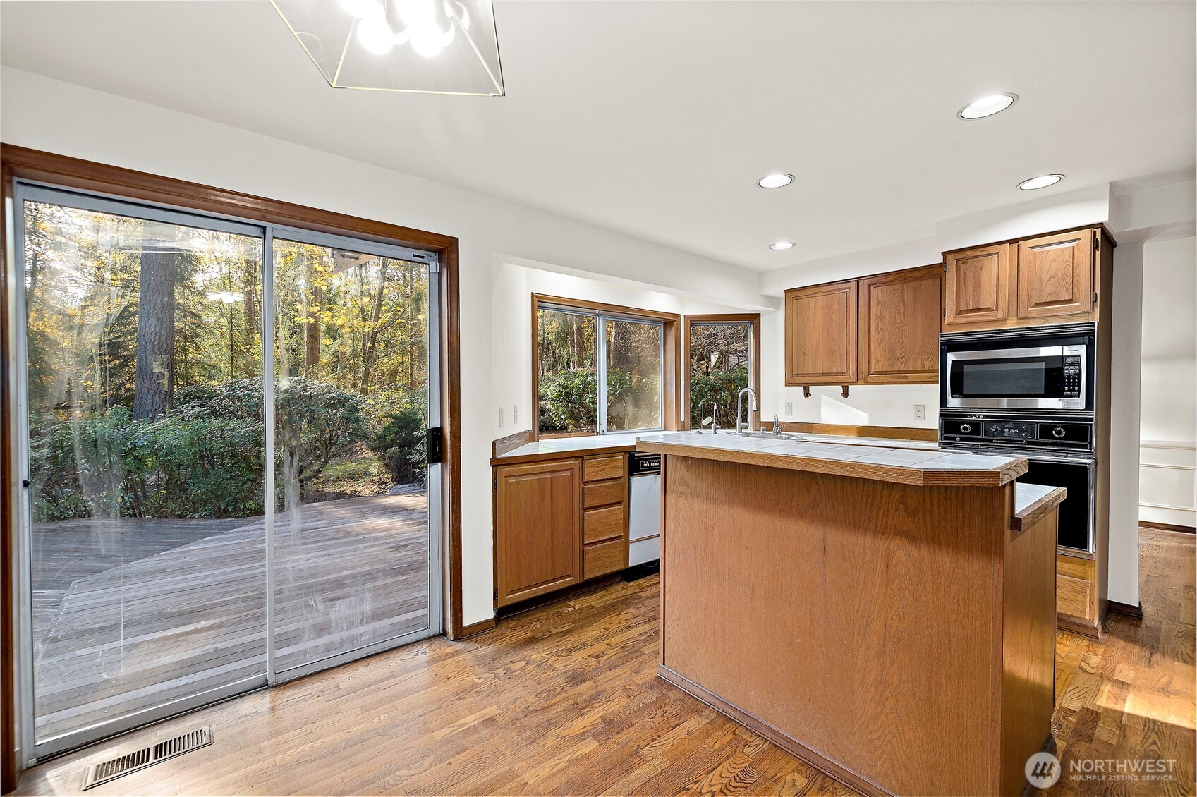 18721 Northeast 133rd Street Redmond, WA 98052 - Photo 8 of 39 a kitchen with granite countertop a stove top oven and sink