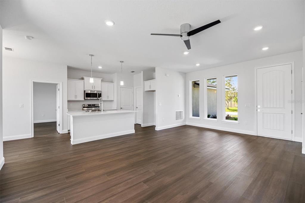 52 Pershing Lane Palm Coast, FL 32164 - Photo 12 of 37 a view of kitchen with stainless steel appliances kitchen island wooden floors wooden cabinets and window