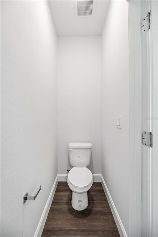 52 Pershing Lane Palm Coast, FL 32164 - Photo 19 of 37 a white toilet sitting in a bathroom