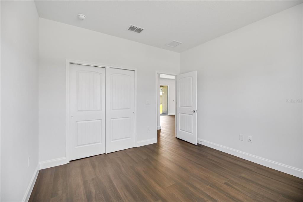 52 Pershing Lane Palm Coast, FL 32164 - Photo 21 of 37 a view of a room with wooden floor and white doors