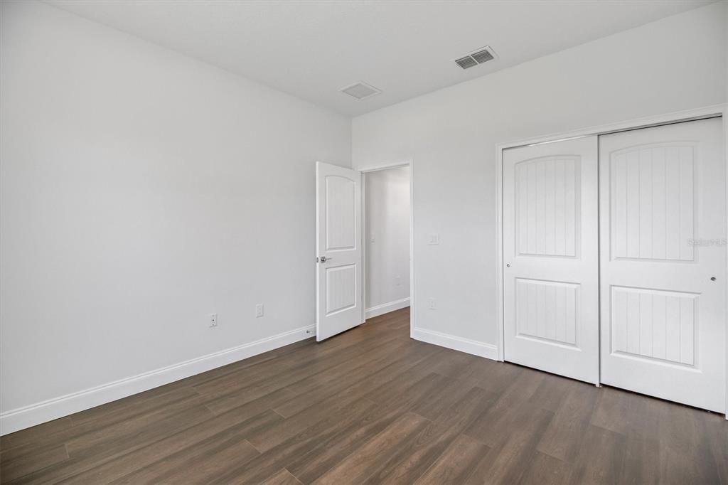 52 Pershing Lane Palm Coast, FL 32164 - Photo 25 of 37 a view of an empty room and wooden floor