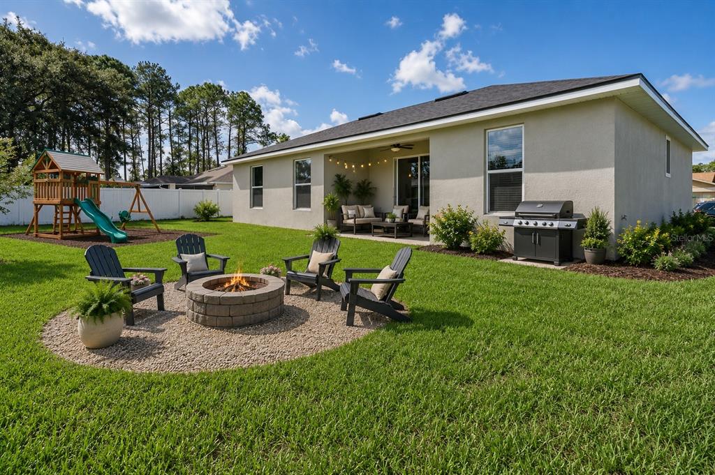 52 Pershing Lane Palm Coast, FL 32164 - Photo 29 of 37 a view of a house with backyard sitting area and garden