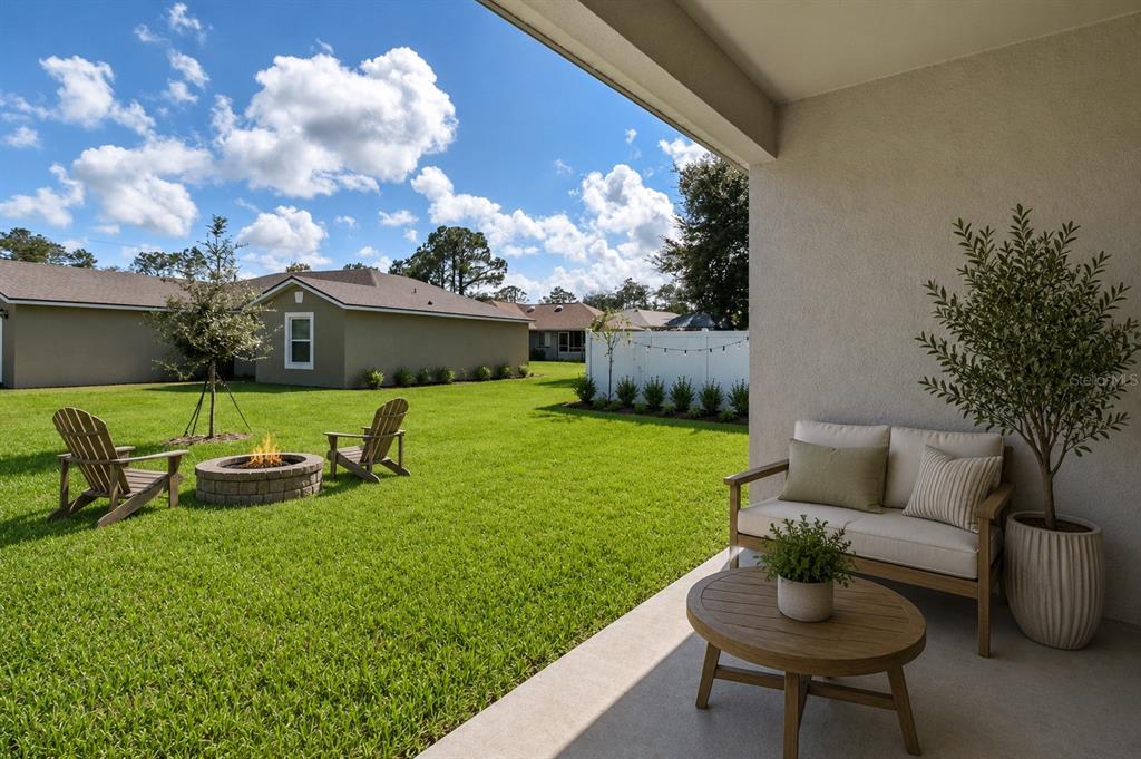 52 Pershing Lane Palm Coast, FL 32164 - Photo 30 of 37 a view of a backyard with plants and a patio