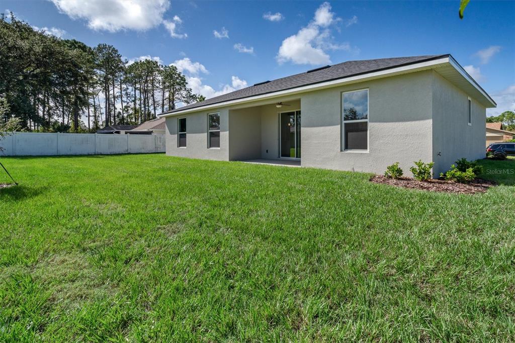 52 Pershing Lane Palm Coast, FL 32164 - Photo 32 of 37 a backyard of a house with lots of green space
