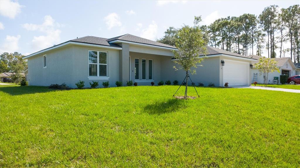 52 Pershing Lane Palm Coast, FL 32164 - Photo 4 of 37 a view of a house with a yard