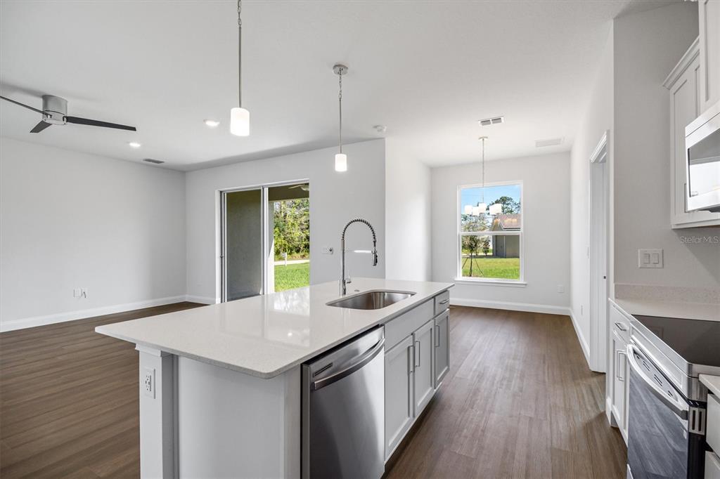 52 Pershing Lane Palm Coast, FL 32164 - Photo 8 of 37 a kitchen with a sink a faucet cabinets and wooden floor