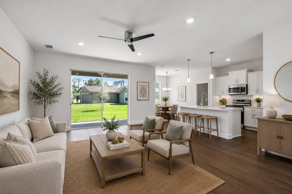 52 Pershing Lane Palm Coast, FL 32164 - Photo 10 of 37 a living room with furniture kitchen view and a large window