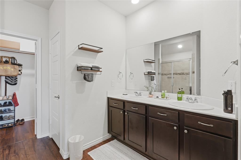 10101 Travis Road Little Elm, TX 75068 - Photo 22 of 26 a bathroom with a double vanity sink and mirror