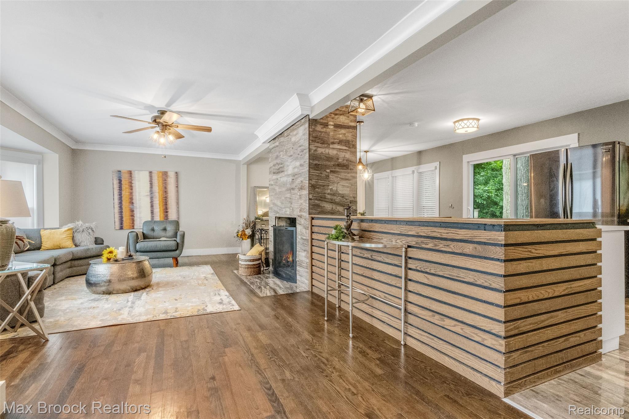 2905 Lahser Road Bloomfield Hills, MI 48304 - Photo 6 of 28 Open concept living area featuring wood-finish flooring and a stone-clad fireplace