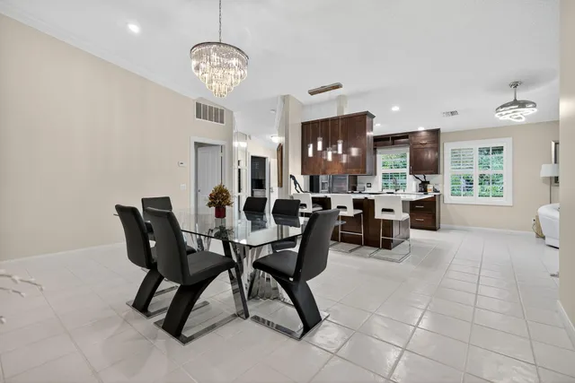 a view of a dining room with furniture and chandelier
