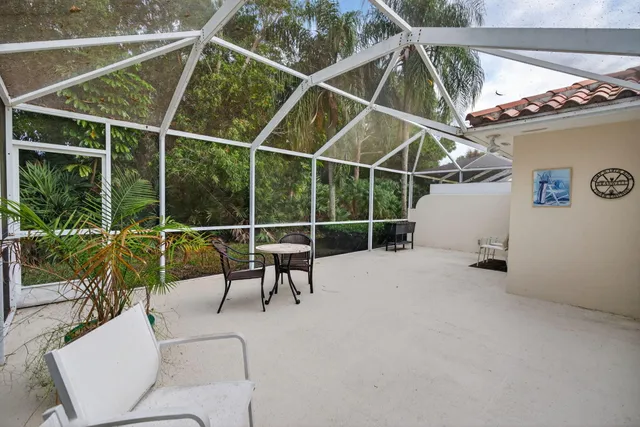 a view of a patio with table and chairs