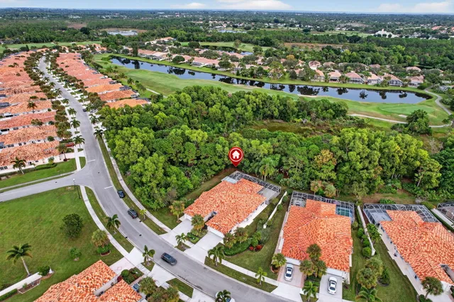 an aerial view of residential houses with outdoor space and river view