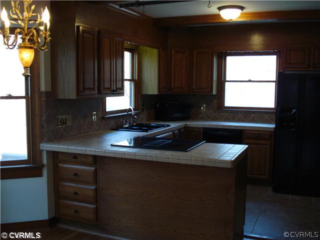 512 Fords Road Manakin-Sabot, VA 23103 - Photo 3 of 10 a kitchen with a sink a window and cabinets