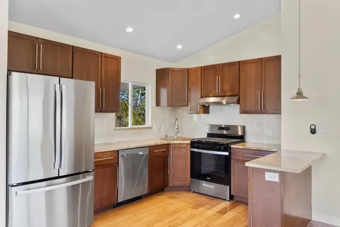 a kitchen with a refrigerator a sink and cabinets
