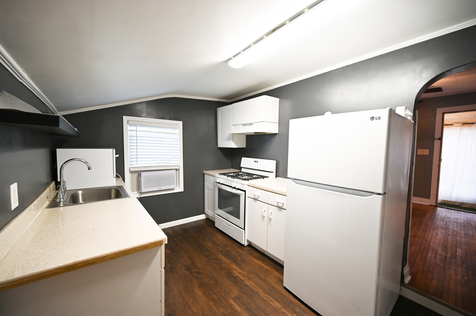 219 South 7th Street DeKalb, IL 60115 - Photo 16 of 30 a kitchen with a refrigerator a stove top oven a sink and a window