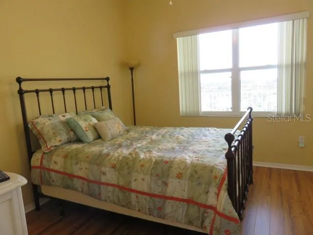 a bed sitting in a bedroom next to a window