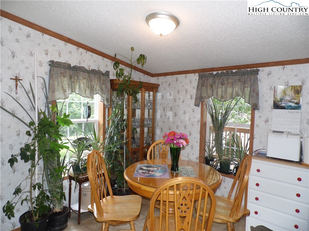 528 Stewart Road Ennice, NC 28623 - Photo 12 of 46 a dining room with furniture and wooden floor