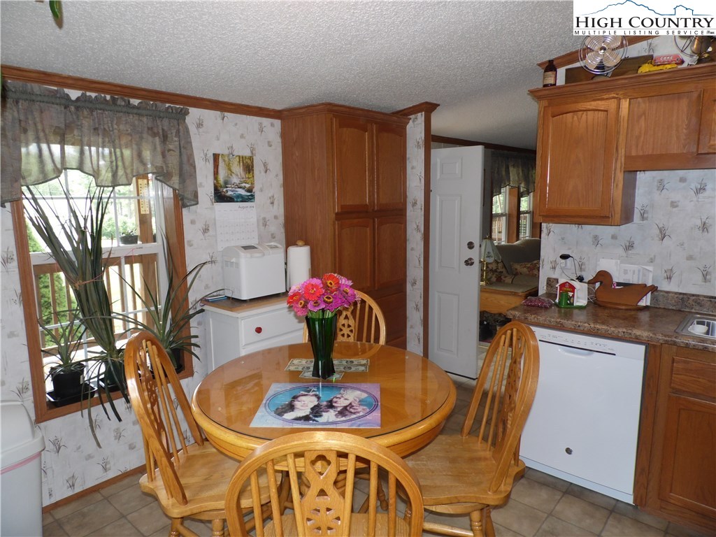 528 Stewart Road Ennice, NC 28623 - Photo 13 of 46 a view of a dining room with furniture and chandelier