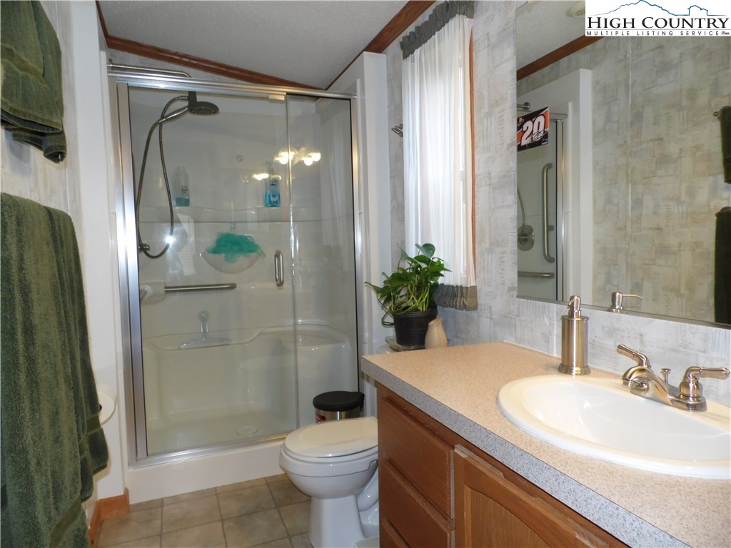 528 Stewart Road Ennice, NC 28623 - Photo 16 of 46 a bathroom with a sink a toilet and shower