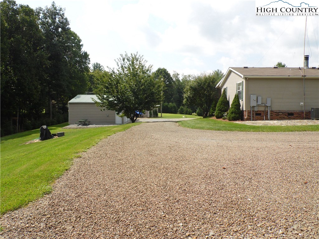 528 Stewart Road Ennice, NC 28623 - Photo 37 of 46 a front view of a house with a yard and trees