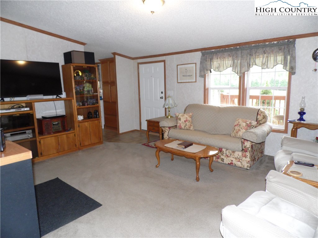 528 Stewart Road Ennice, NC 28623 - Photo 8 of 46 a living room with furniture and a flat screen tv