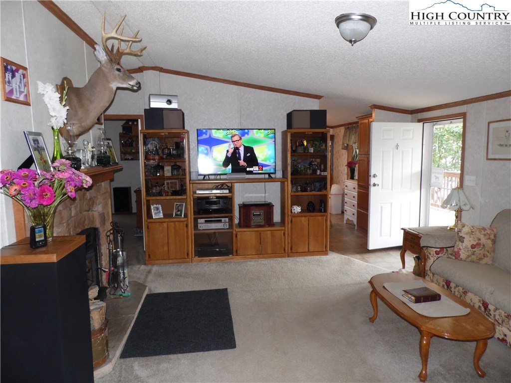 528 Stewart Road Ennice, NC 28623 - Photo 9 of 46 a living room with furniture and a flat screen tv