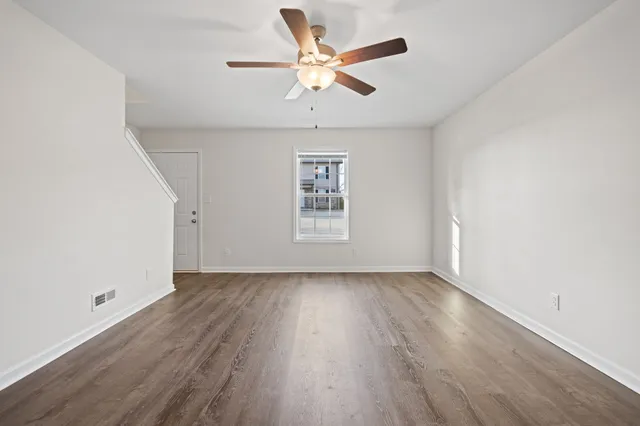 wooden floor in an empty room with a window