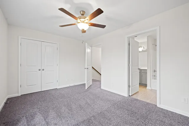 wooden floor in an empty room and a ceiling fan