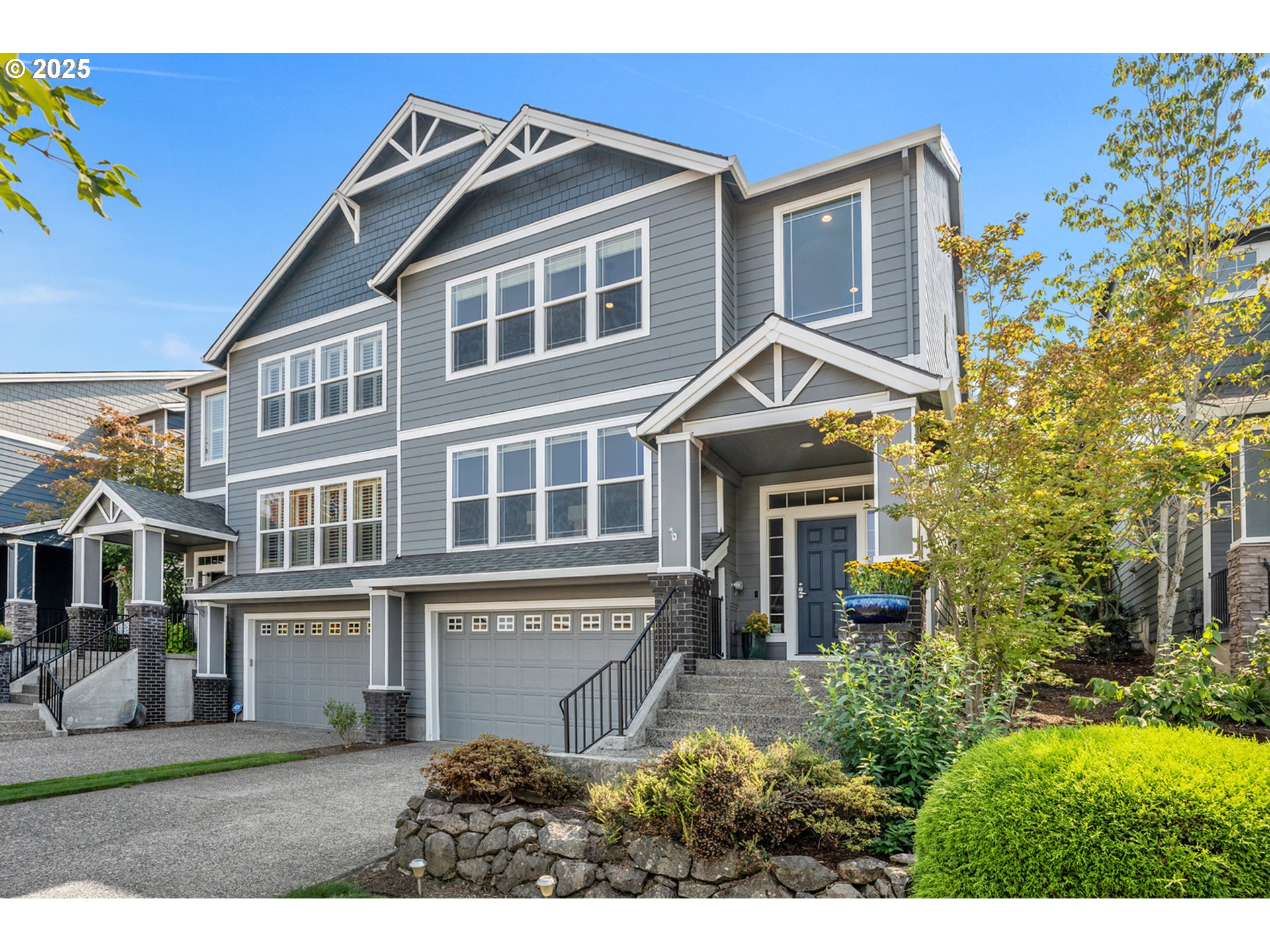 15702 Southwest Snowy Owl Lane Beaverton, OR 97007 - Photo 1 of 44 a front view of a house with a garden