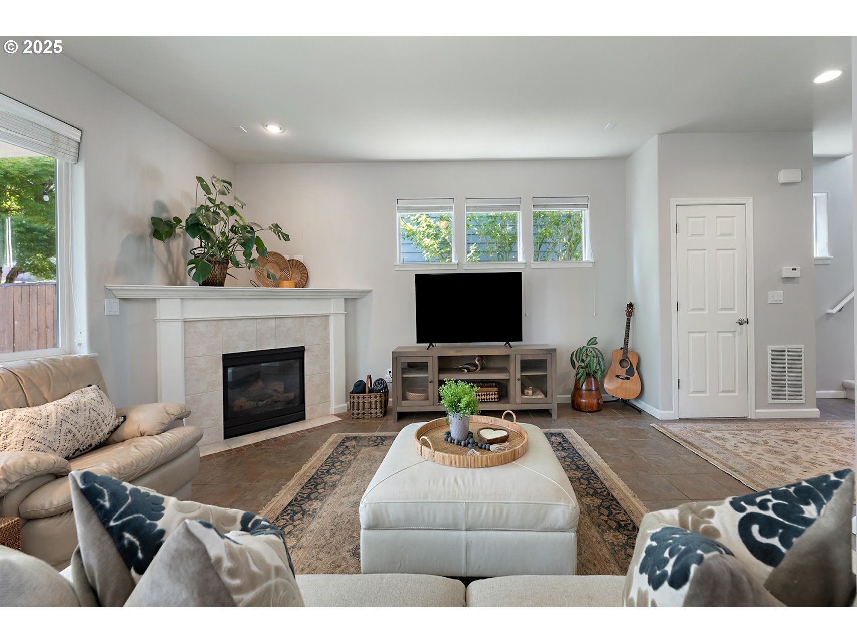 15702 Southwest Snowy Owl Lane Beaverton, OR 97007 - Photo 17 of 44 a living room with furniture a flat screen tv and a fireplace