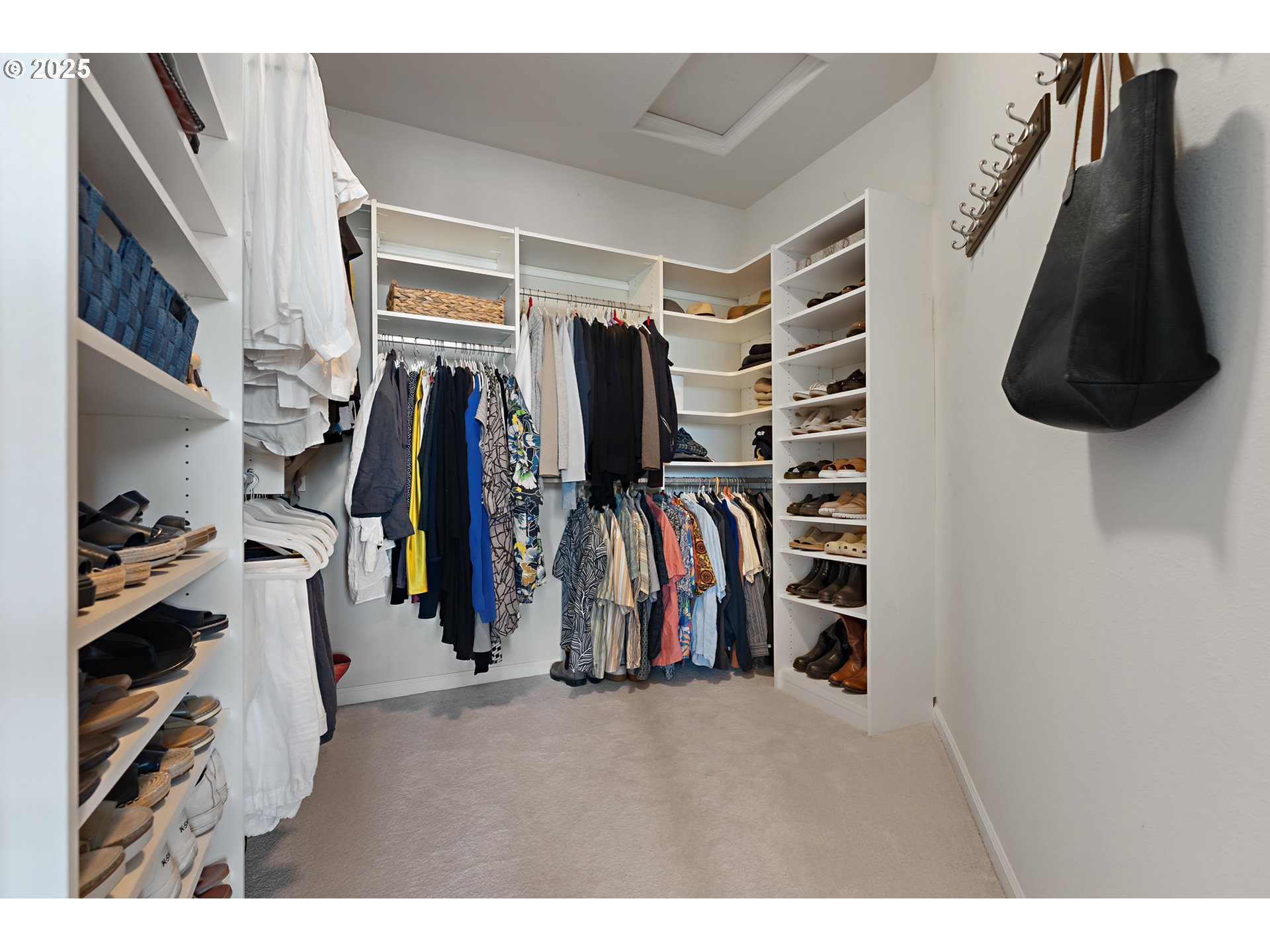 15702 Southwest Snowy Owl Lane Beaverton, OR 97007 - Photo 31 of 44 a view of walk in closet with clothes and shoes