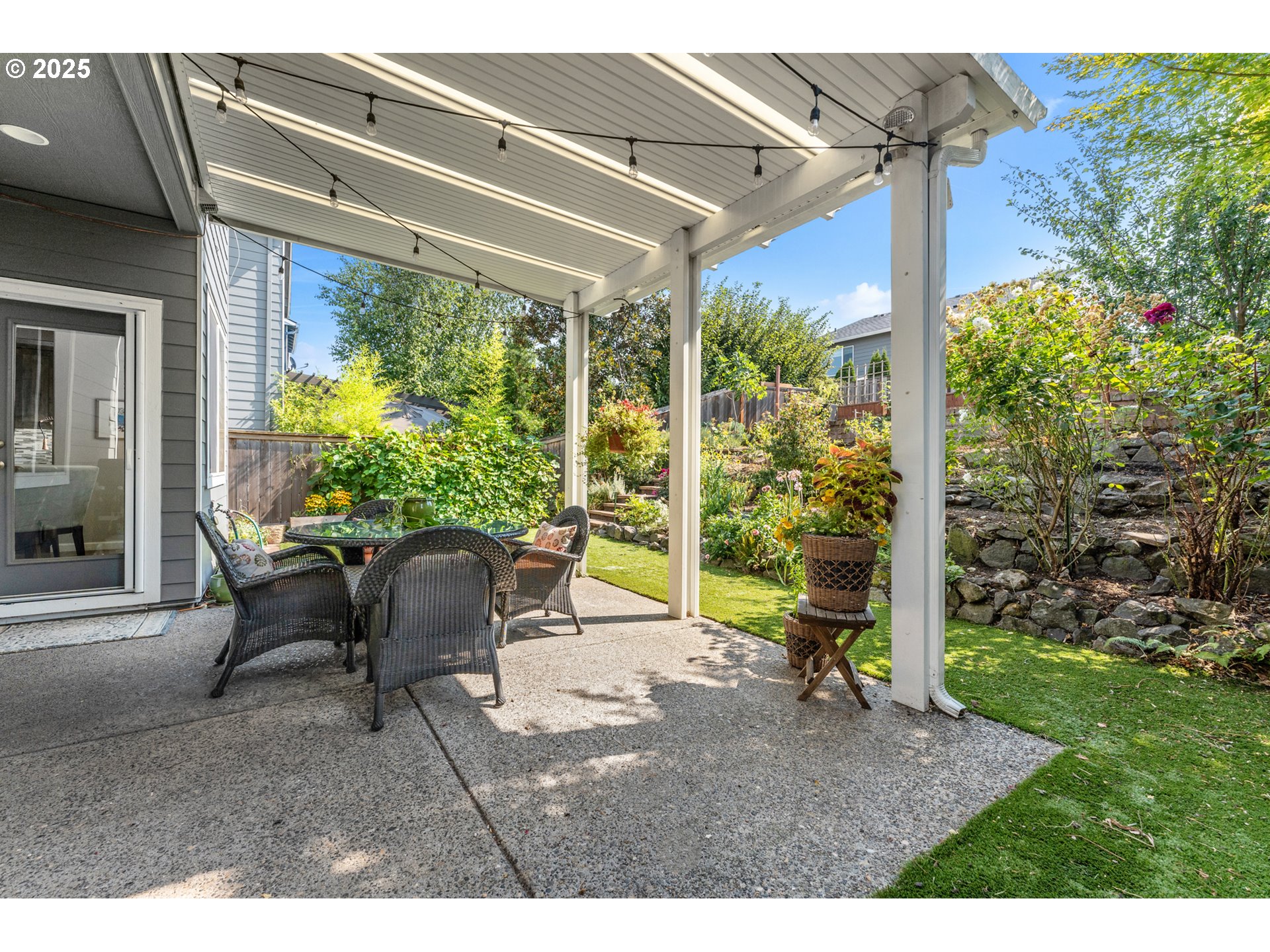 15702 Southwest Snowy Owl Lane Beaverton, OR 97007 - Photo 36 of 44 a view of a patio with table and chairs and potted plants