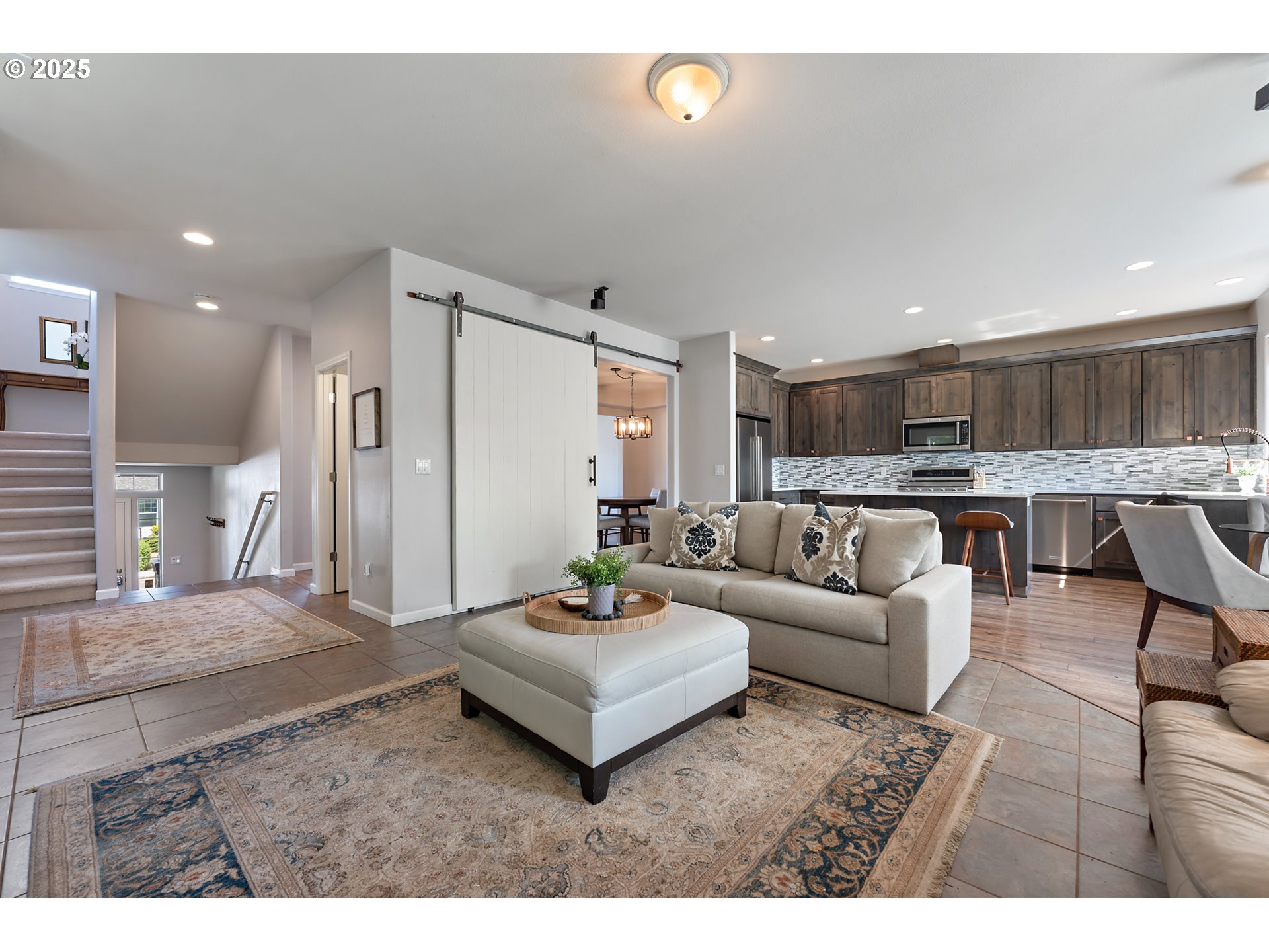 15702 Southwest Snowy Owl Lane Beaverton, OR 97007 - Photo 4 of 44 a living room with stainless steel appliances kitchen island furniture and a view of kitchen