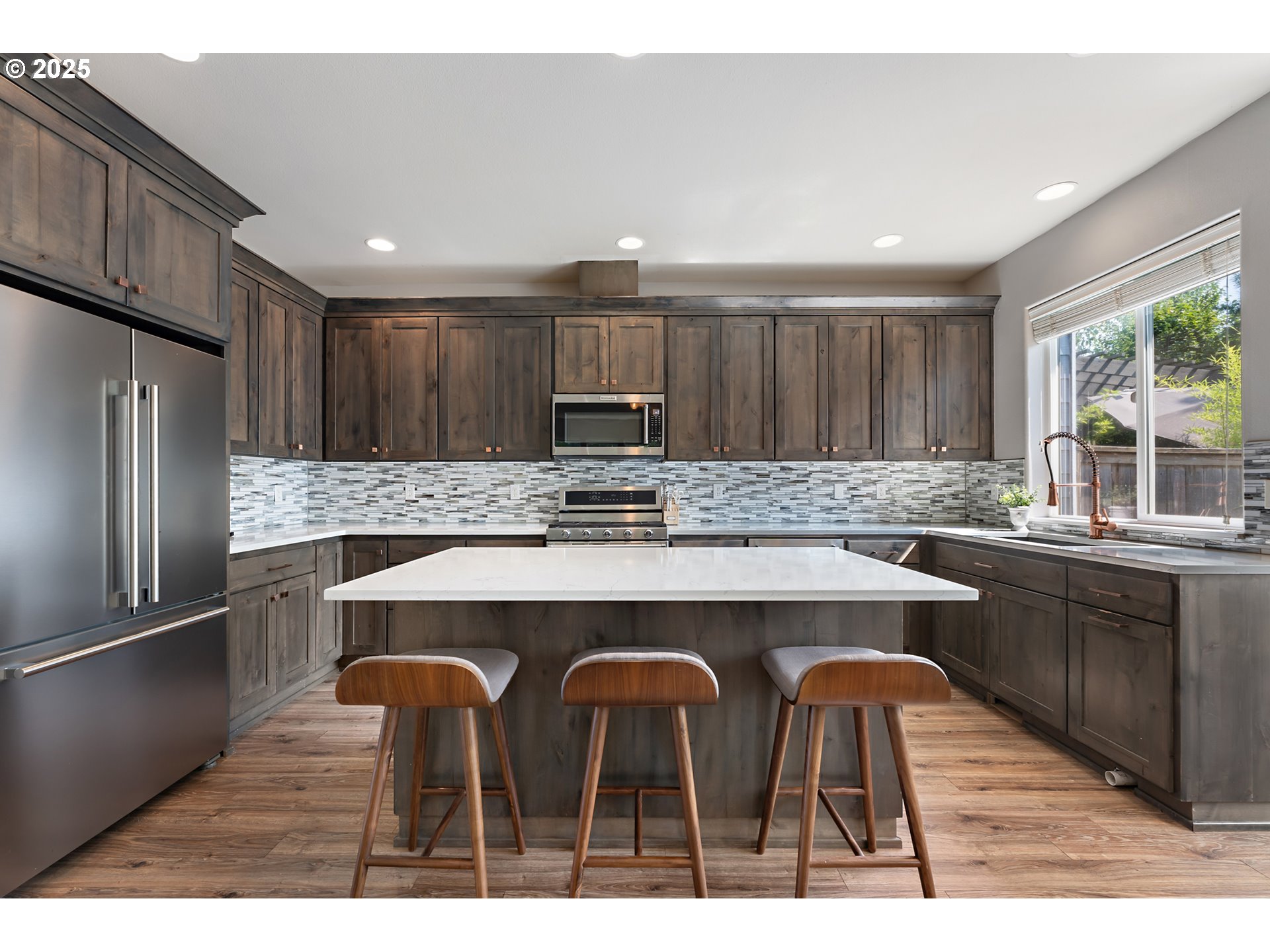 15702 Southwest Snowy Owl Lane Beaverton, OR 97007 - Photo 9 of 44 a kitchen with cabinets a counter space stainless steel appliances and windows