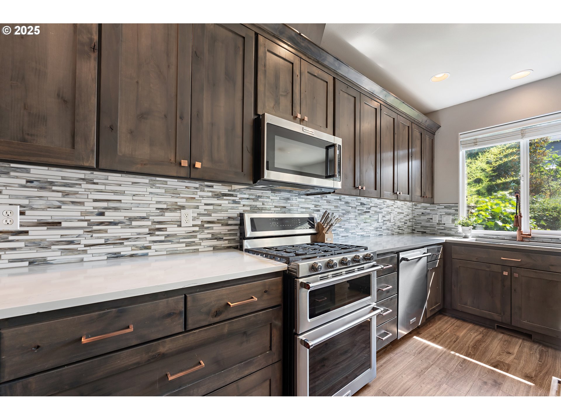15702 Southwest Snowy Owl Lane Beaverton, OR 97007 - Photo 10 of 44 a kitchen with granite countertop cabinets stainless steel appliances and a counter space