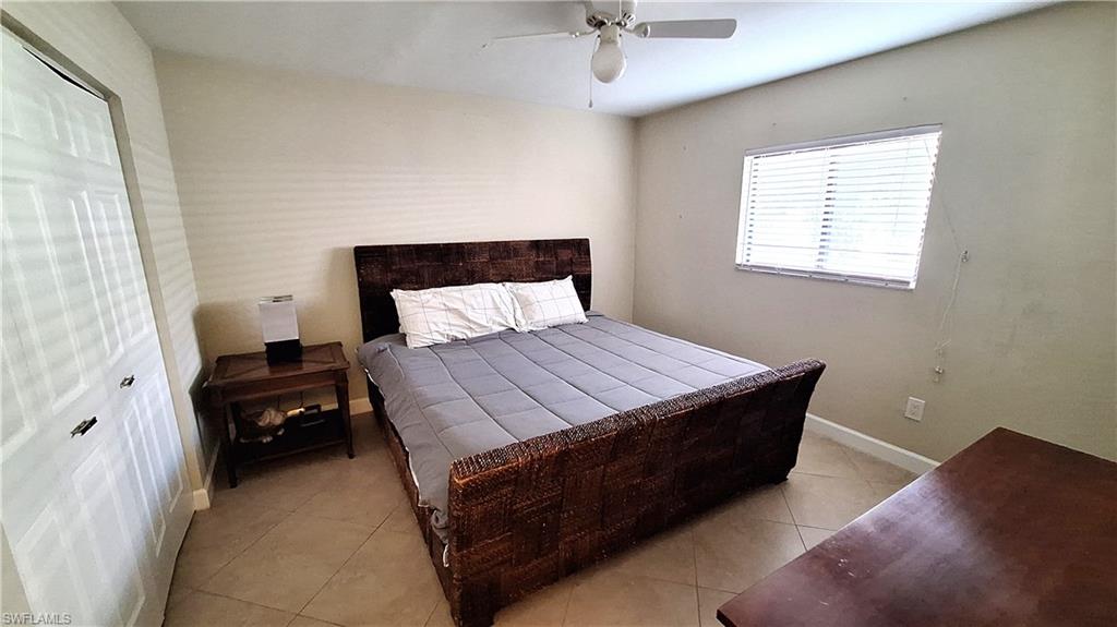 910 Vanderbilt Beach Road, Unit 416E Naples, FL 34108 - Photo 12 of 16 a bedroom with a bed and a window