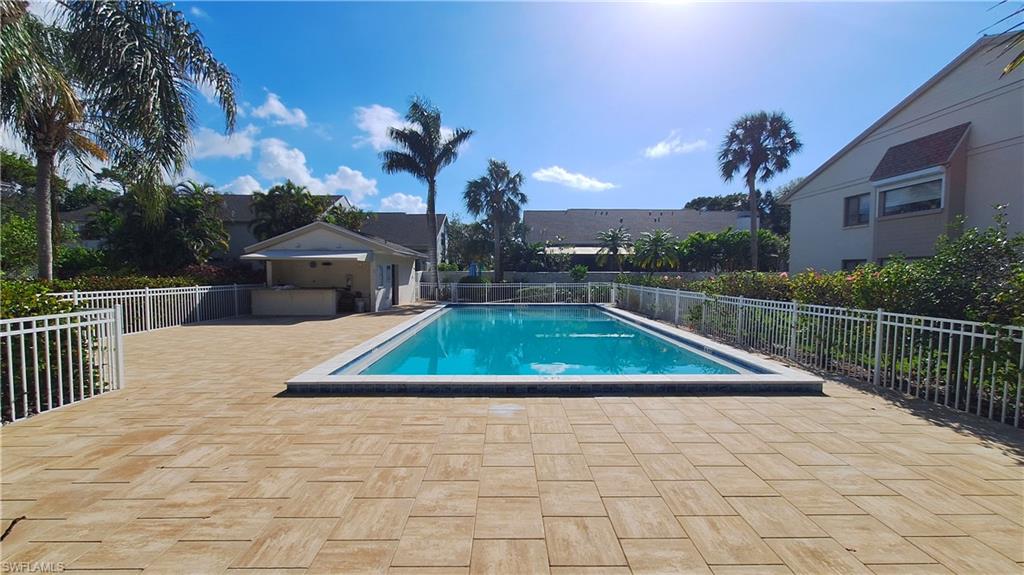 910 Vanderbilt Beach Road, Unit 416E Naples, FL 34108 - Photo 4 of 16 a view of a pool with a yard