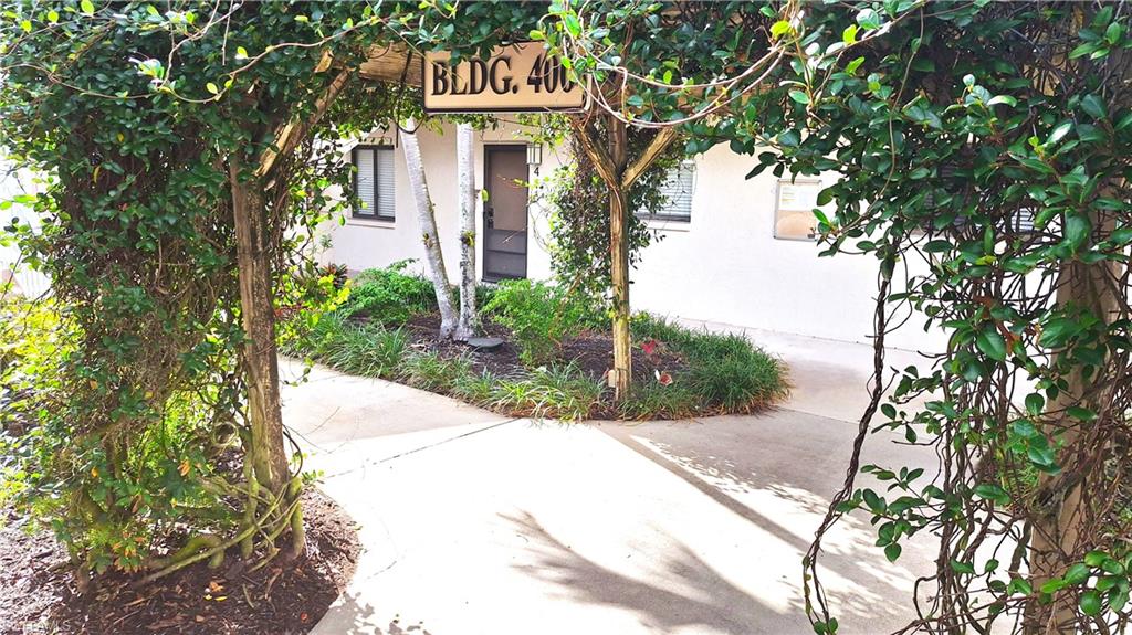 910 Vanderbilt Beach Road, Unit 416E Naples, FL 34108 - Photo 5 of 16 a front view of a house with a tree