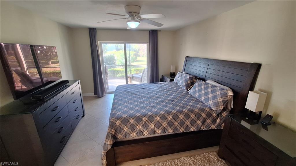 910 Vanderbilt Beach Road, Unit 416E Naples, FL 34108 - Photo 10 of 16 a bedroom with a bed and a flat tv screen on dresser
