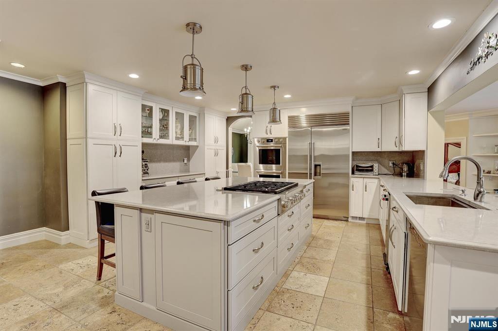 4 Summertree Way Montvale, NJ 07645 - Photo 17 of 50 a kitchen with stainless steel appliances kitchen island granite countertop a sink and cabinets