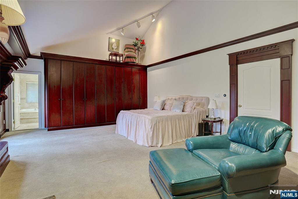 4 Summertree Way Montvale, NJ 07645 - Photo 25 of 50 a bedroom with a bed and a mirror