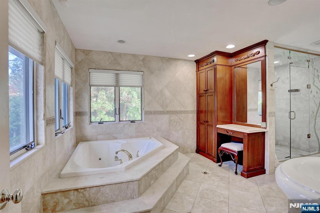 4 Summertree Way Montvale, NJ 07645 - Photo 26 of 50 a bathroom with a tub and a window