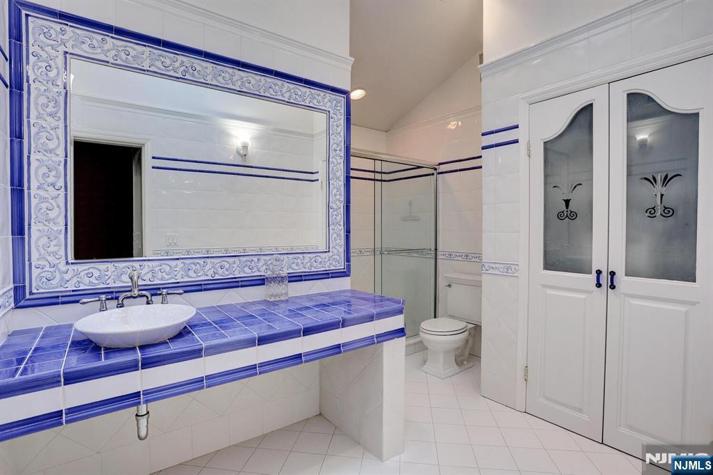 4 Summertree Way Montvale, NJ 07645 - Photo 29 of 50 a bathroom with a sink a toilet and shower