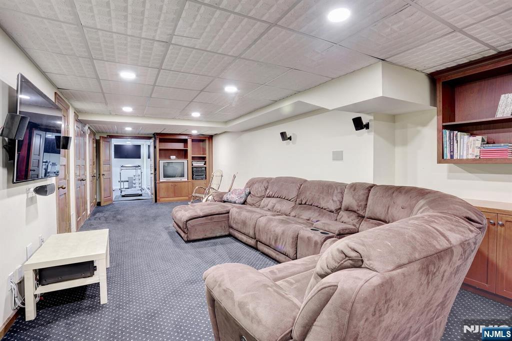 4 Summertree Way Montvale, NJ 07645 - Photo 32 of 50 a living room with furniture and a flat screen tv